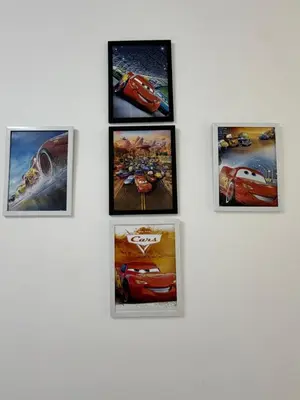 a group of framed pictures on a wall at AYAAN McQUEEN Featured House with ps3 experience Most Wanted 2012 Racing games in Tanah Rata