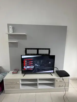a flat screen tv sitting on a white entertainment center at AYAAN McQUEEN Featured House with ps3 experience Most Wanted 2012 Racing games in Tanah Rata