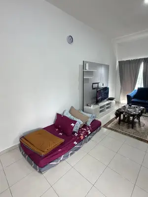 a bed sitting in a living room with a tv at AYAAN McQUEEN Featured House with ps3 experience Most Wanted 2012 Racing games in Tanah Rata