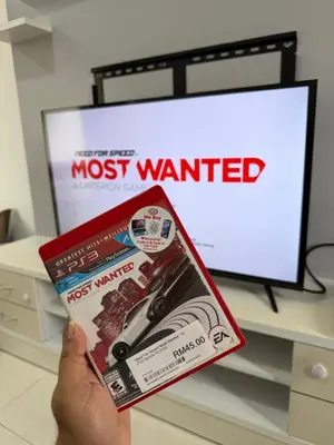 a person is holding a most wanted magazine at AYAAN McQUEEN Featured House with ps3 experience Most Wanted 2012 Racing games in Tanah Rata