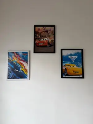 a group of four pictures hanging on a wall at AYAAN McQUEEN Featured House with ps3 experience Most Wanted 2012 Racing games in Tanah Rata