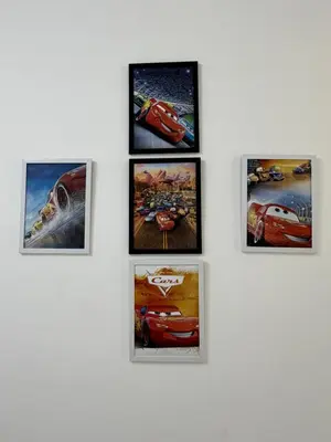 a group of framed pictures on a wall at AYAAN McQUEEN Featured House with ps3 experience Most Wanted 2012 Racing games in Tanah Rata