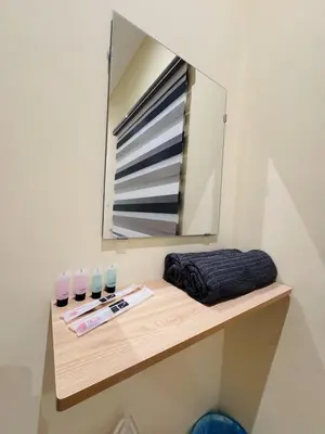 a mirror on top of a wooden shelf with glasses at Homestay Cozy Dino Cameron Highlands in Tanah Rata