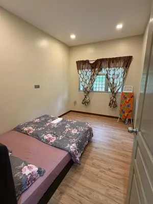 a bedroom with a bed and a window at AYAAN MILLENIUM Family Homestay with Netflix and PS3 xprience Most Wanted 2012 and many more racing games in Tanah Rata