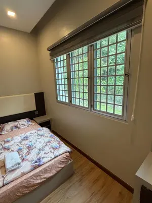 a bedroom with a bed and a large window at AYAAN MILLENIUM Family Homestay with Netflix and PS3 xprience Most Wanted 2012 and many more racing games in Tanah Rata