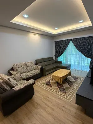 a living room with a couch and a table at AYAAN MILLENIUM Family Homestay with Netflix and PS3 xprience Most Wanted 2012 and many more racing games in Tanah Rata