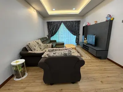 a living room with a couch and a chair at AYAAN MILLENIUM Family Homestay with Netflix and PS3 xprience Most Wanted 2012 and many more racing games in Tanah Rata