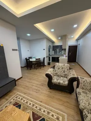 a living room with a couch and a table at AYAAN MILLENIUM Family Homestay with Netflix and PS3 xprience Most Wanted 2012 and many more racing games in Tanah Rata