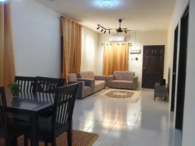 a living room with a table and a couch at FF Home - Homestay Teluk Intan in Teluk Intan