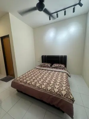 a bed in a room with a ceiling fan at FF Home - Homestay Teluk Intan in Teluk Intan