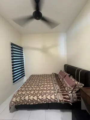 a bedroom with a bed with a ceiling fan at FF Home - Homestay Teluk Intan in Teluk Intan