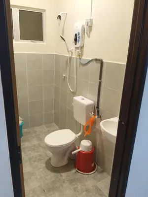 a bathroom with a toilet and a sink at FF Home - Homestay Teluk Intan in Teluk Intan