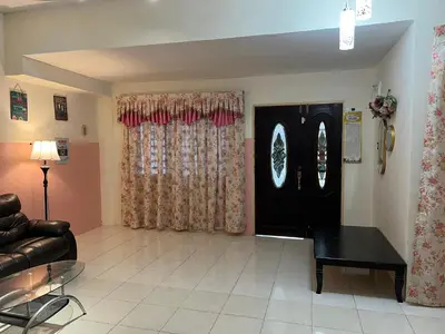 a living room with a black door and curtains at Homestay Adelia SI in Seri Iskandar