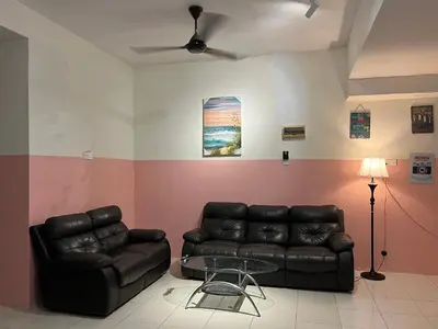 a living room with a couch and a glass table at Homestay Adelia SI in Seri Iskandar