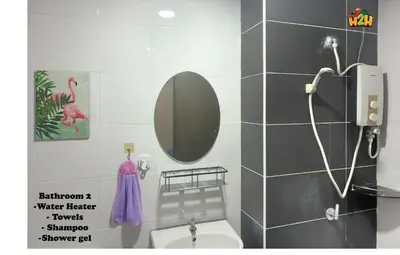 a bathroom with a mirror and a white toilet at H2H- Dreamy Home - Majestic Ipoh - 7 pax in Ipoh