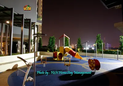 a playground with a slide in a city at night at H2H- Dreamy Home - Majestic Ipoh - 7 pax in Ipoh