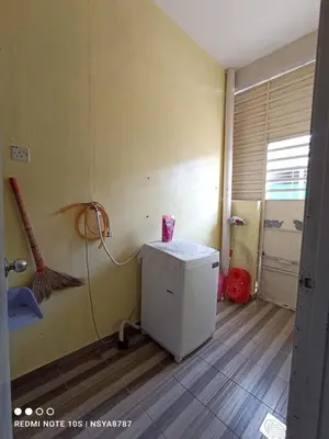 a room with a small refrigerator and a broom at De Ariffa Homestay مسلم in Lahat