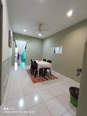 a dining room with a table and chairs at De Ariffa Homestay مسلم in Lahat