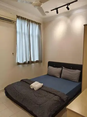 a bedroom with a bed with a towel on it at Warmy 4 Bedrooms Double Storey Homestay, Few mins to Town, by MR HOMESTAY in Teluk Intan