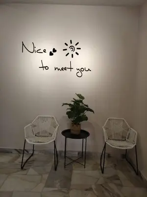 three chairs and a table with a plant on a wall at Warmy 4 Bedrooms Double Storey Homestay, Few mins to Town, by MR HOMESTAY in Teluk Intan