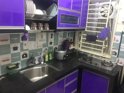 a kitchen with purple cabinets and a stainless steel sink at Zamdynas HomestayMuslim Cameron Highland in Tanah Rata