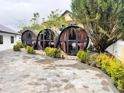 a house with two domes in the middle of a yard at Aurelia Stay in Brinchang