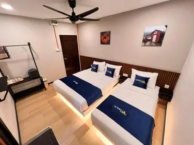 a bedroom with two beds and a ceiling fan at Aurelia Stay in Brinchang