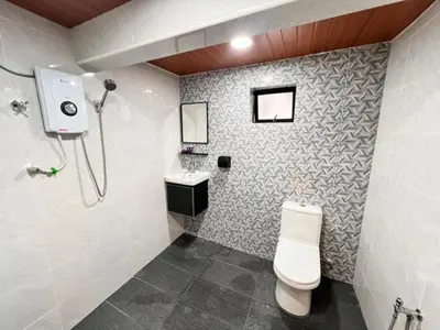 a bathroom with a toilet and a sink and a shower at Aurelia Stay in Brinchang