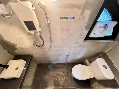a bathroom with two toilets and a sink and a shower at Aurelia Stay in Brinchang