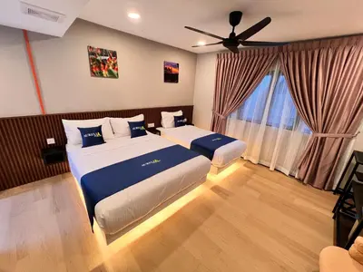 a bedroom with two beds and a large window at Aurelia Stay in Brinchang