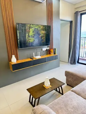 a living room with a couch and a table at Piccadilly Ipoh by Iconique in Ipoh