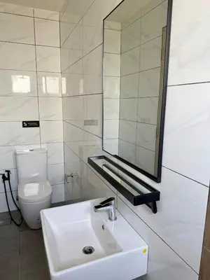 a bathroom with a sink and a mirror and a toilet at Piccadilly Ipoh by Iconique in Ipoh