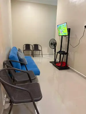 a room with chairs and a tv in a room at Teratak Bonda in Temuh