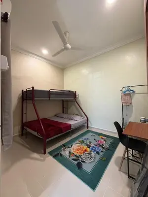 a bedroom with a bunk bed and a rug at Teratak Bonda in Temuh