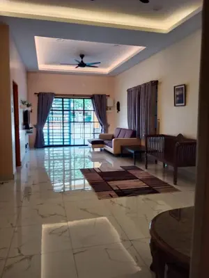 a living room with a couch and a table at Empatnurul Homestay Ipoh in Ipoh