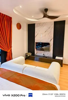 a bedroom with a white couch and a marble wall at Adik Aisyah Hotel Studio Room Sun Harvest Citrus Centrum Brinchang in Brinchang