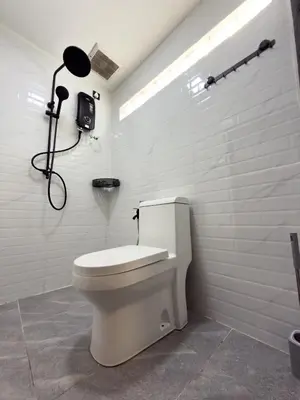 a bathroom with a toilet and a shower at Swit60 Homestay in Sungai Besar