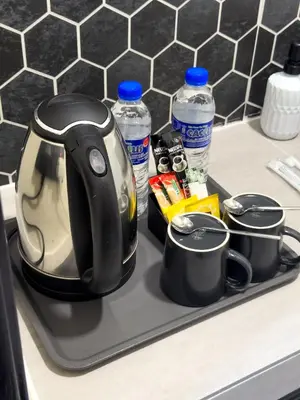 a tea kettle on a tray on a kitchen counter at Swit60 Homestay in Sungai Besar