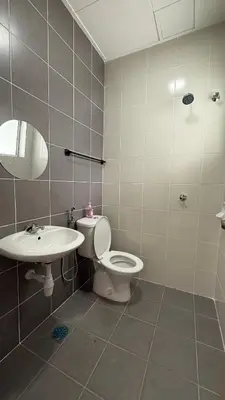 a bathroom with a toilet and a sink at Homestay Azizi in Seri Iskandar