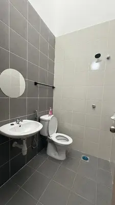a bathroom with a toilet and a sink at Homestay Azizi in Seri Iskandar