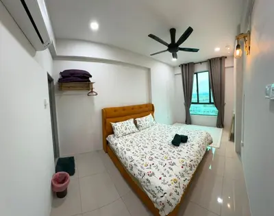 a bedroom with a bed and a ceiling fan at Idham homestay 2 in Ipoh
