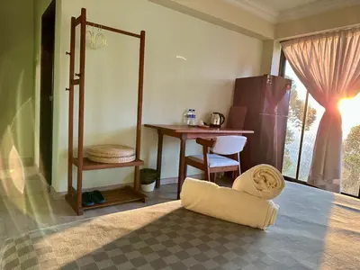 a room with a desk and a table with a mirror at Bao Sheng Durian Farm in Balik Pulau