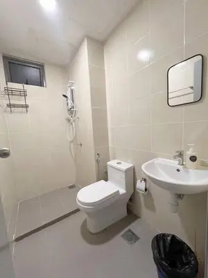 a white bathroom with a toilet and a sink at Norlinda palas homestay in Brinchang