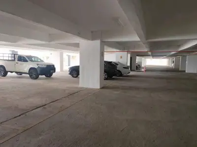 a parking lot with cars parked in a parking garage at Norlinda palas homestay in Brinchang