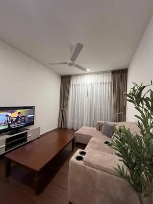 a living room with a couch and a flat screen tv at Norlinda palas homestay in Brinchang