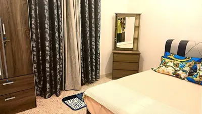 a bedroom with a bed and a dresser and a mirror at A K Homestay in Sungai Petani