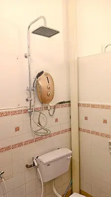 a bathroom with a toilet with a shower head at A K Homestay in Sungai Petani
