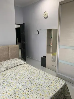 a bedroom with a bed and a clock on the wall at Homestay D'Kutan Bandar Baharu Kedah in Bandar Baharu