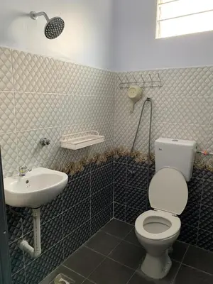 a bathroom with a toilet and a sink at Homestay D'Kutan Bandar Baharu Kedah in Bandar Baharu