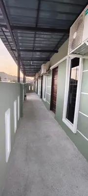 an empty hallway of a building with a roof at 3Q Impiana Roomstay Teluk Senangin in Lumut